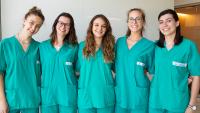 Five international students smiling together.